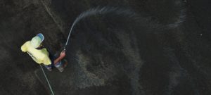 Spraying water over an asphalt surface